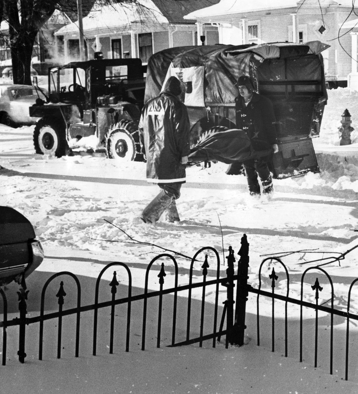 Firemen, using a National Guard vehicle, take an elderly Omaha woman to St. Joseph Hospital on January 12, 1975.